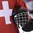 POPRAD, SLOVAKIA - APRIL 14: A Switzerland player holds his helmet during the playing of the Swiss national anthem following a 4-0 win against Latvia during preliminary round action at the 2017 IIHF Ice Hockey U18 World Championship. (Photo by Andrea Cardin/HHOF-IIHF Images)

